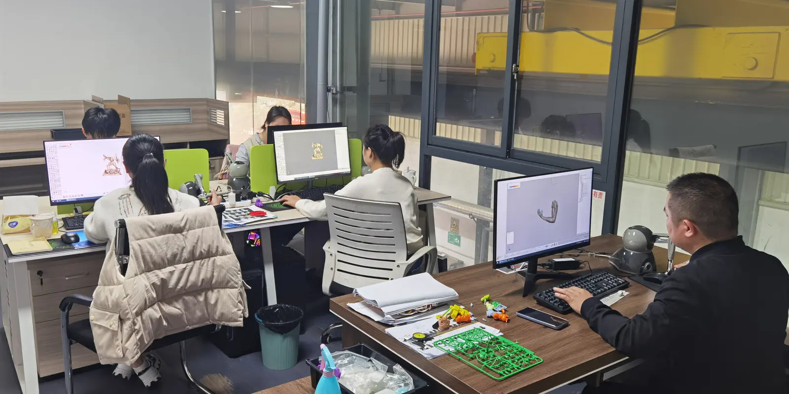 Engineering team reviewing 3D product data and molded model components