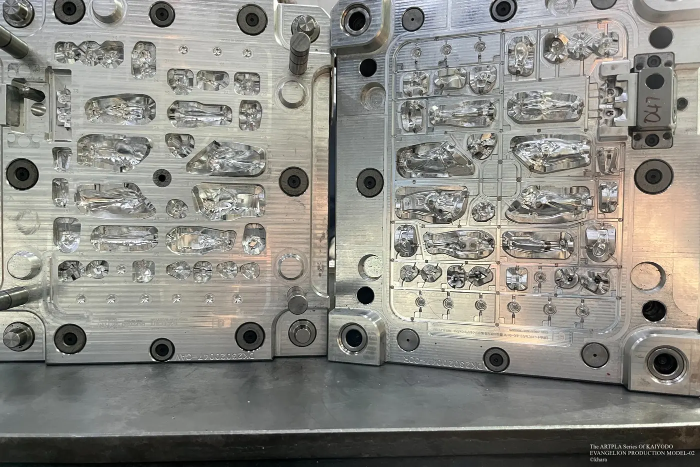 Open metal mold with long component cavities and small circular details