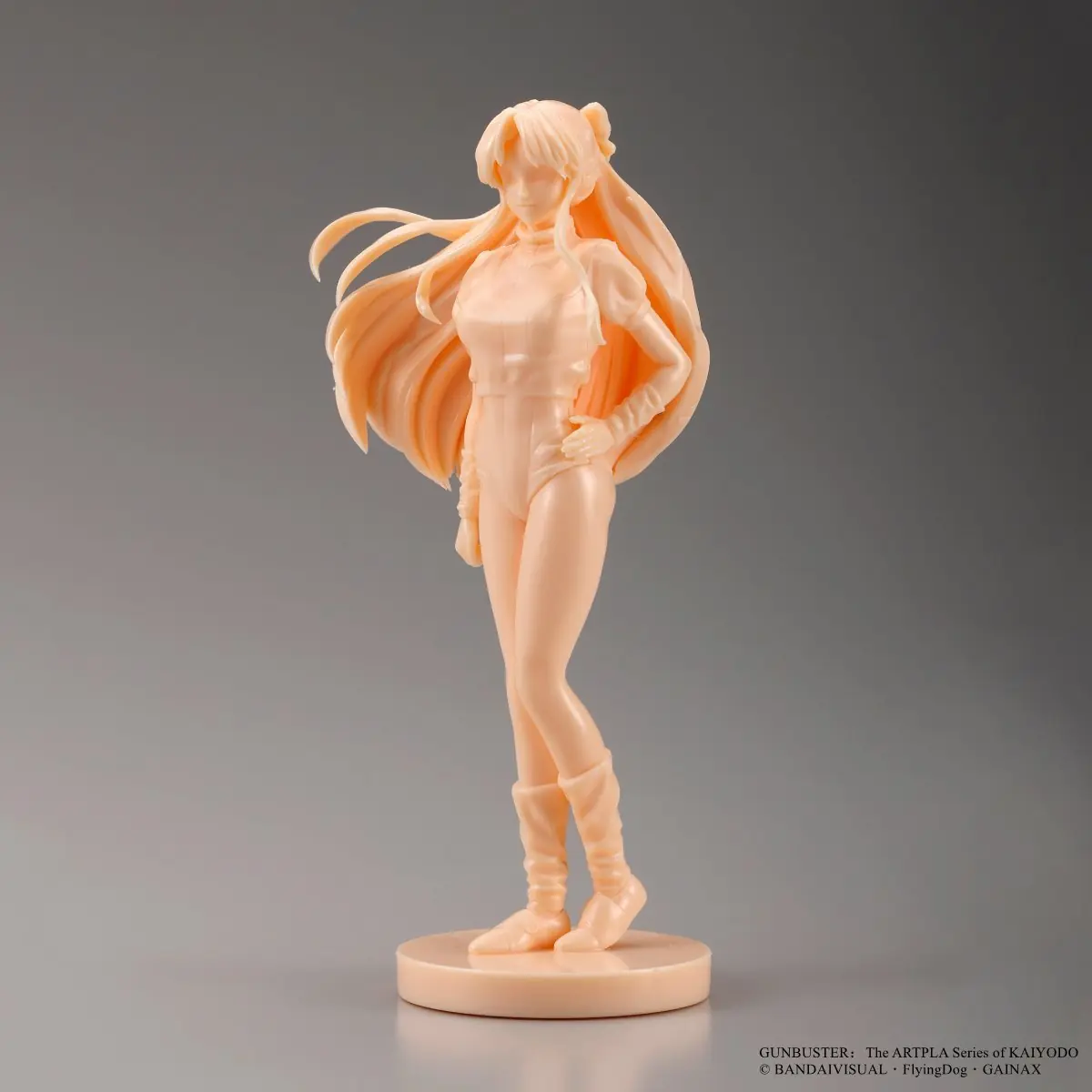 Single-color pale-orange long-haired character figure standing on a round base