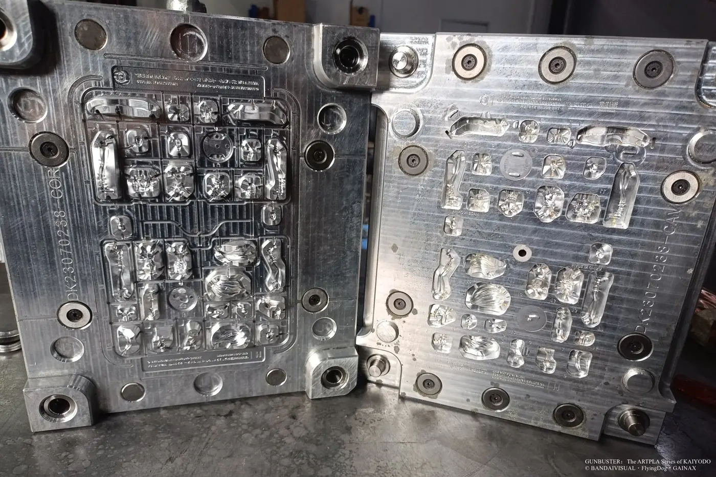 Open metal mold containing character body, hair and round base cavities