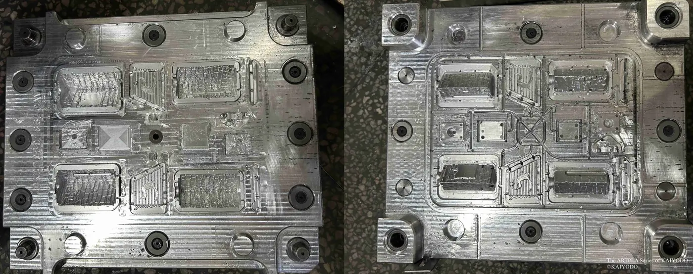 Two metal tooling plates containing several rectangular component cavities
