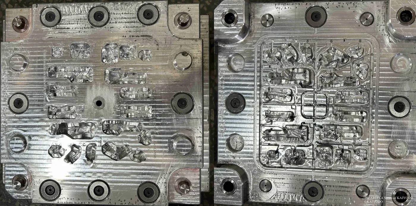 Two metal tooling plates containing multiple small figure and accessory-shaped cavities